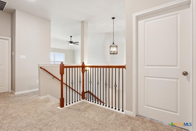 corridor with light colored carpet