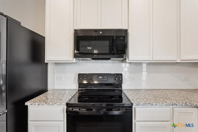 kitchen featuring white cabinetry, decorative backsplash, black appliances, and light stone counters