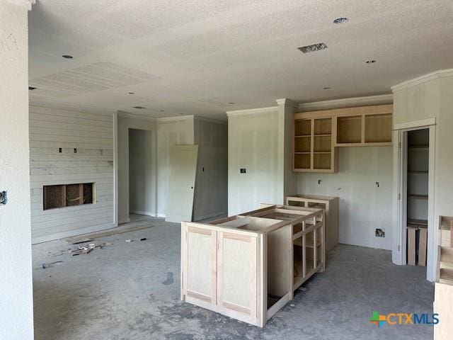3718 Oglala Trl, Temple, TX 76502 - kitchen with a fireplace, a kitchen island, and a textured ceiling