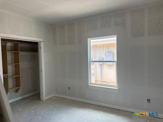 3718 Oglala Trl, Temple, TX 76502 - unfurnished bedroom with baseboards and a textured ceiling