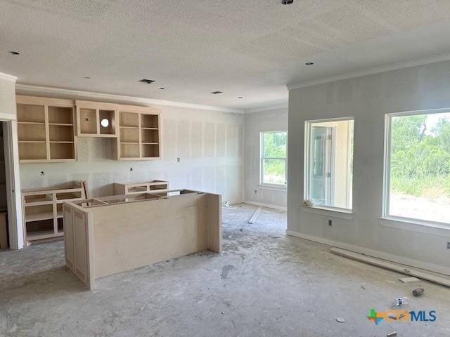 3718 Oglala Trl, Temple, TX 76502 - kitchen featuring ornamental molding, a kitchen island, and a textured ceiling