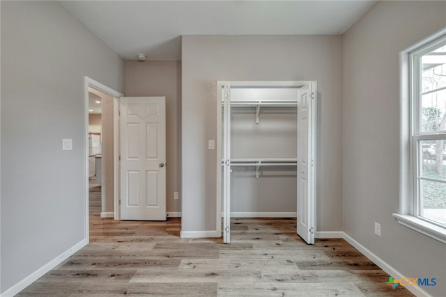 1408 Armstrong St, Luling, TX 78648 - unfurnished bedroom featuring wood finished floors and a closet