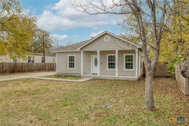 view of front of house with a front yard and a porch