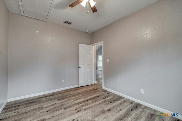 spare room with ceiling fan and light wood-type flooring