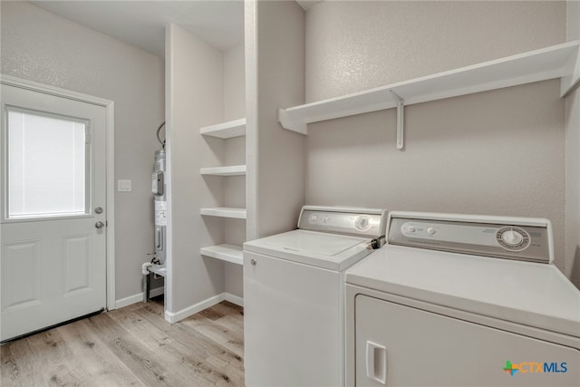 1408 Armstrong St, Luling, TX 78648 - laundry room featuring light wood finished floors, washing machine and clothes dryer, and water heater