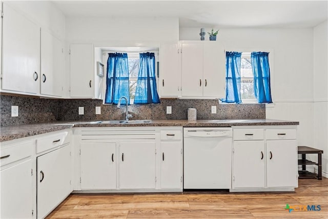 1016 E Elm St, Hillsboro, TX 76645 - kitchen with light wood finished floors, backsplash, dishwasher, white cabinetry, and a sink
