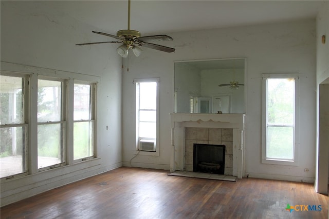 unfurnished living room featuring a wealth of natural light, hardwood / wood-style flooring, and ceiling fan