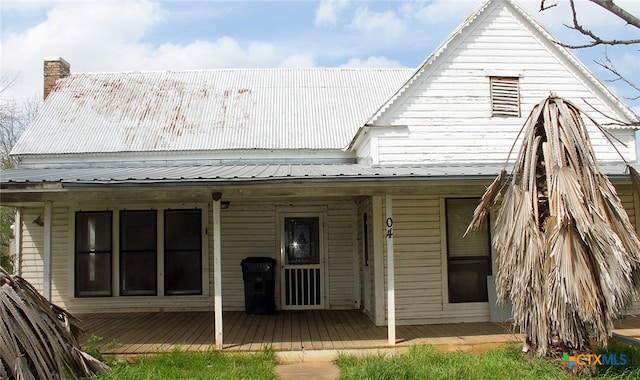 rear view of property with a porch