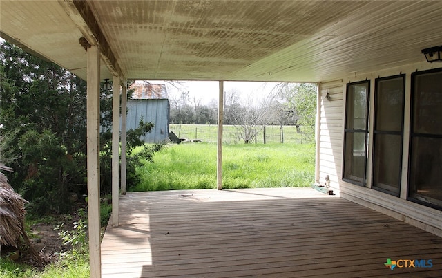 wooden deck featuring a lawn