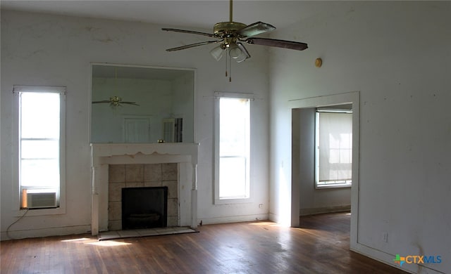 unfurnished living room featuring hardwood / wood-style flooring, ceiling fan, and plenty of natural light