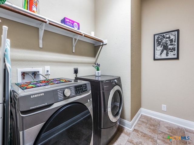 washroom featuring washing machine and dryer