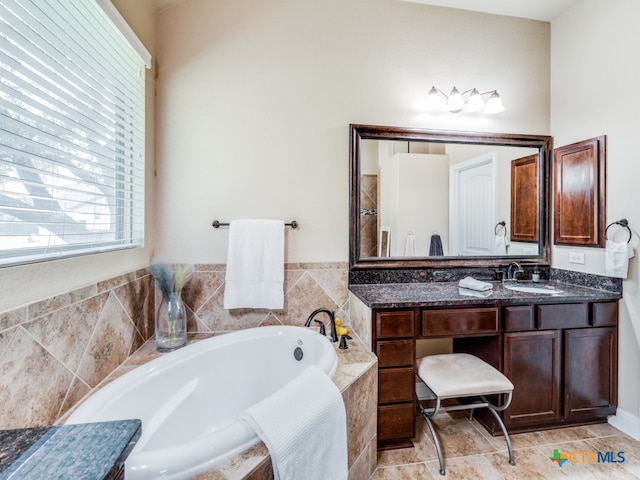 bathroom with a relaxing tiled tub and vanity