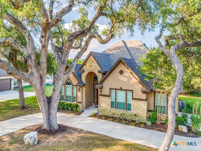 view of front of property with a front lawn and a garage