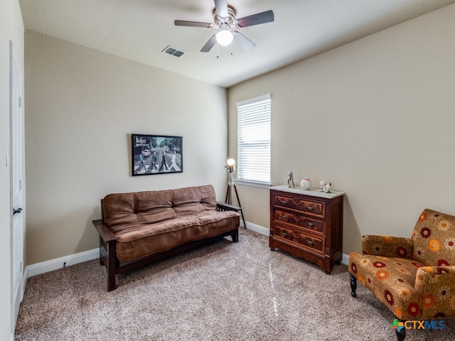 living area featuring ceiling fan and light colored carpet