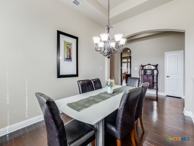 dining room featuring dark hardwood / wood-style floors and a chandelier