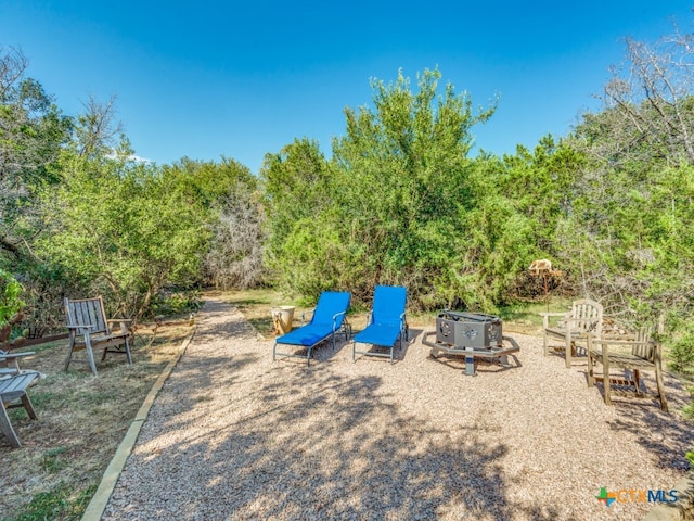 view of jungle gym with an outdoor fire pit