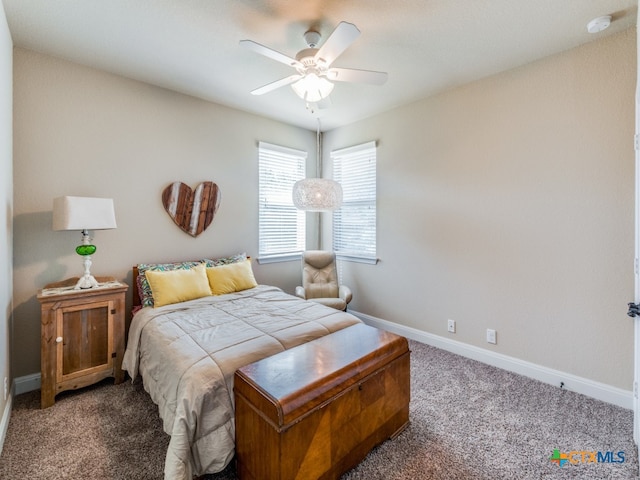 bedroom with dark carpet and ceiling fan