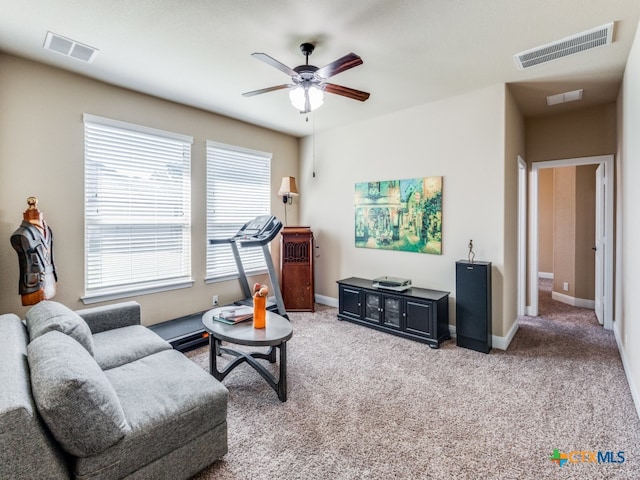 living room featuring ceiling fan and carpet