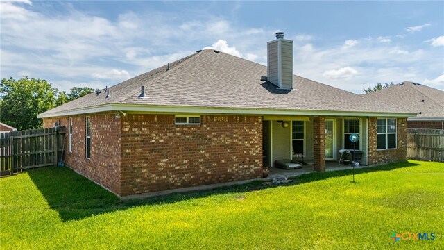 1809 Indian Camp Trl, Copperas Cove, TX 76522 - rear view of property with a fenced backyard, brick siding, a chimney, and roof with shingles