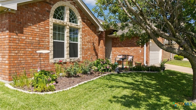 1809 Indian Camp Trl, Copperas Cove, TX 76522 - view of side of property featuring brick siding, a lawn, and an attached garage