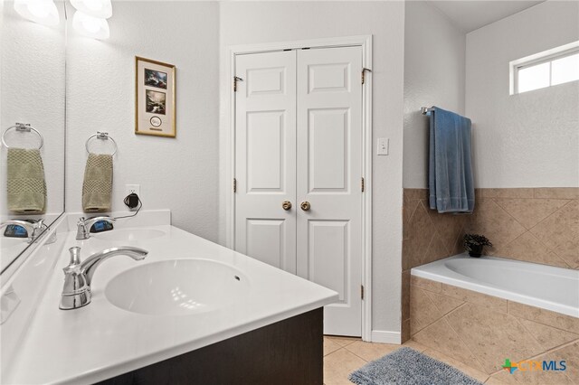 1809 Indian Camp Trl, Copperas Cove, TX 76522 - full bathroom featuring double vanity, tile patterned flooring, and a garden tub