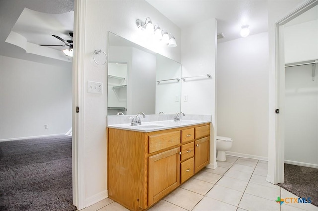 4902 Slate Ct, Killeen, TX 76542 - bathroom featuring ceiling fan, double vanity, toilet, a walk in closet, and tile patterned flooring