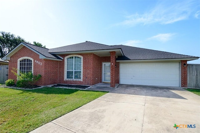 4902 Slate Ct, Killeen, TX 76542 - single story home featuring brick siding, concrete driveway, a front lawn, an attached garage, and roof with shingles