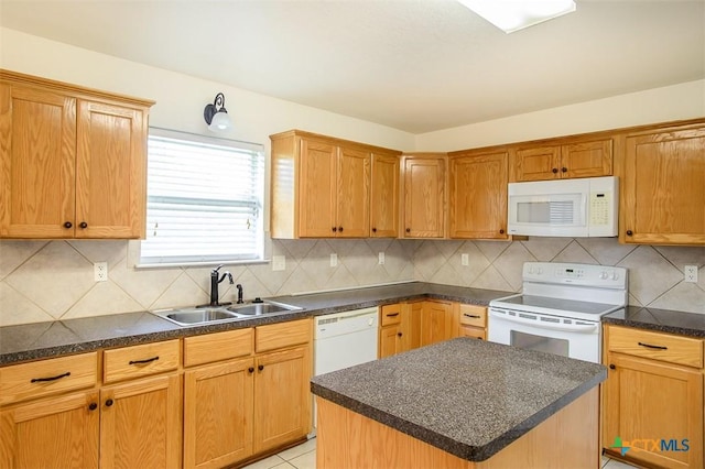 4902 Slate Ct, Killeen, TX 76542 - kitchen featuring white appliances, a sink, backsplash, dark countertops, and a kitchen island