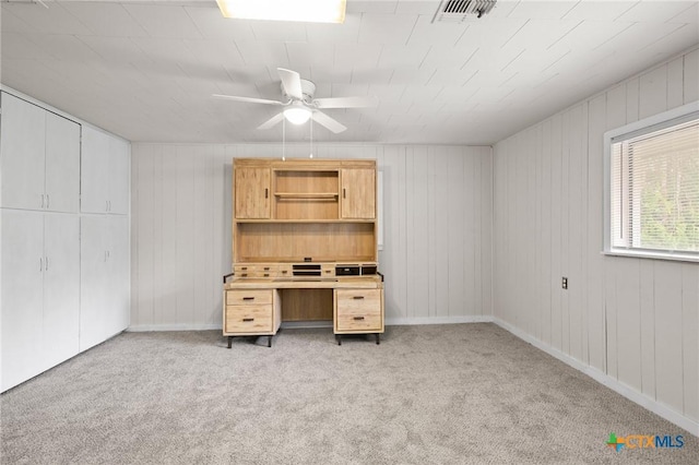 unfurnished office with ceiling fan and light colored carpet