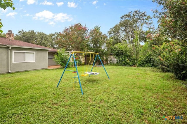 view of jungle gym featuring a lawn