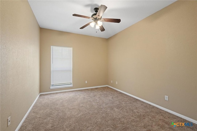 unfurnished room featuring carpet flooring, a ceiling fan, and baseboards