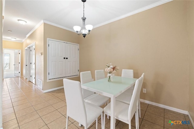 dining space featuring light tile patterned floors, baseboards, a chandelier, and crown molding