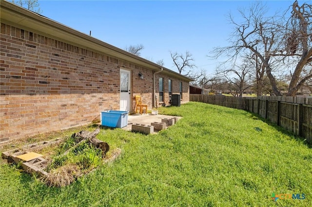 view of yard featuring central AC unit and a fenced backyard