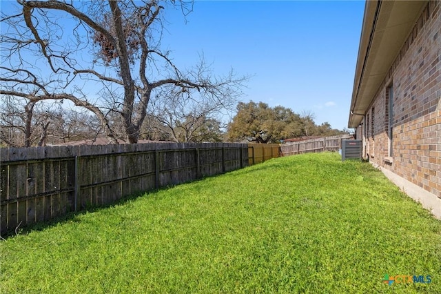 view of yard featuring central air condition unit and a fenced backyard