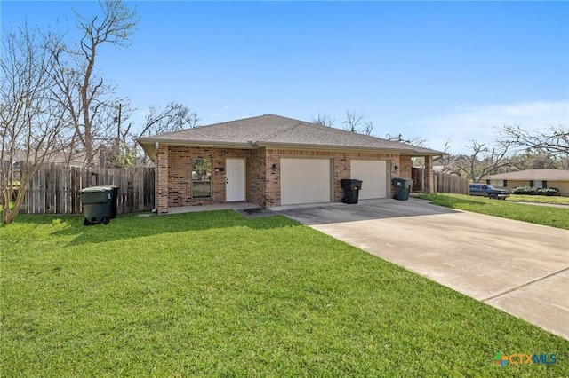 view of front of home featuring driveway, fence, an attached garage, a front yard, and brick siding