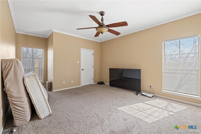 interior space featuring a ceiling fan, baseboards, carpet floors, and ornamental molding