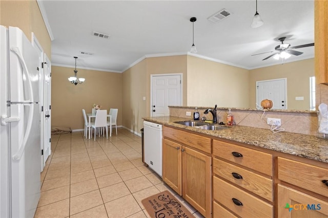 kitchen featuring visible vents, ornamental molding, white appliances, and a sink