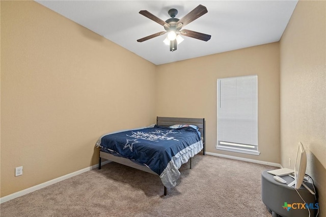 bedroom with a ceiling fan, baseboards, and carpet floors