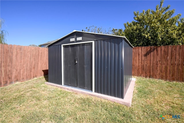 view of outbuilding featuring a lawn