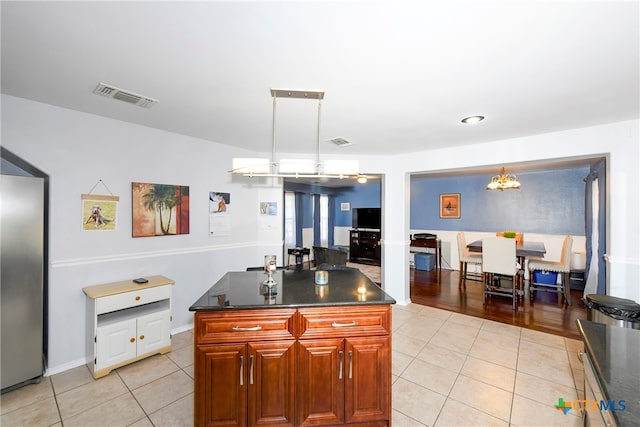 kitchen with a kitchen island, pendant lighting, and light tile patterned floors