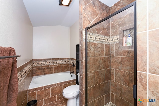 bathroom featuring shower with separate bathtub, toilet, and lofted ceiling