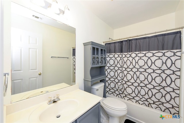 full bathroom featuring toilet, vanity, and shower / tub combo with curtain