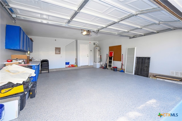 garage with water heater and a garage door opener