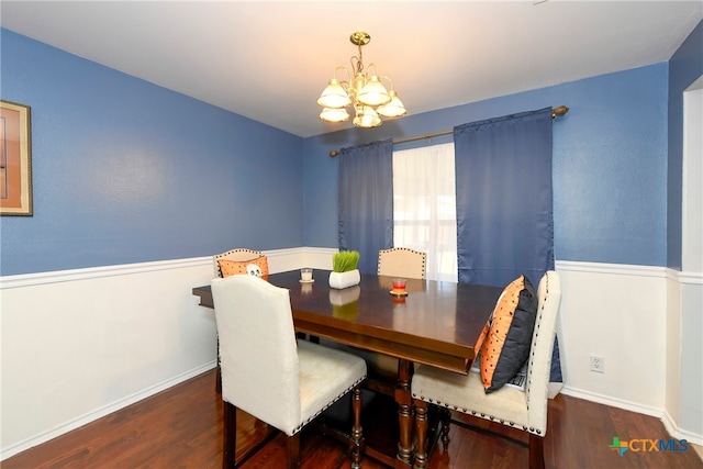 dining area with a chandelier and dark wood-type flooring