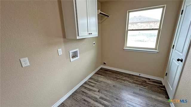 washroom featuring electric dryer hookup, dark wood finished floors, baseboards, cabinet space, and hookup for a washing machine