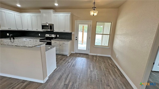 kitchen with dark wood finished floors, white cabinetry, tasteful backsplash, and appliances with stainless steel finishes