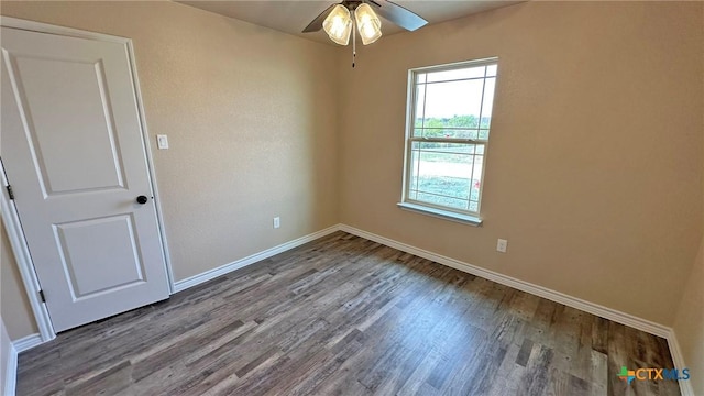 unfurnished room with baseboards, wood finished floors, and a ceiling fan