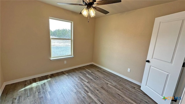 empty room with baseboards, wood finished floors, and a ceiling fan