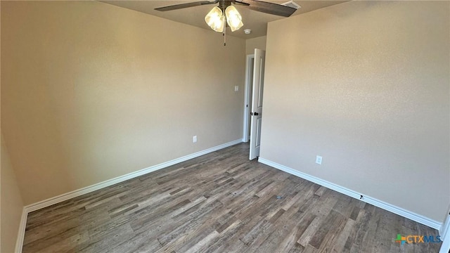 spare room featuring baseboards, wood finished floors, and ceiling fan