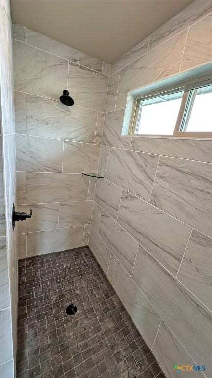 full bath with plenty of natural light and tiled shower